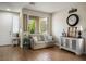 Cozy living room with hardwood floors, comfortable seating, and a welcoming ambiance at 10749 Turquoise Valley Dr, Las Vegas, NV 89144
