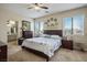 Comfortable main bedroom with a ceiling fan, carpet, and ensuite bathroom at 10749 Turquoise Valley Dr, Las Vegas, NV 89144