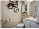 Stylish powder room with a decorative mirror, hexagon shelves, and white vanity at 10749 Turquoise Valley Dr, Las Vegas, NV 89144