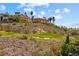 Luxury home overlooking lush green golf course, palm trees and desert landscape at 1134 Pandora Canyon St, Henderson, NV 89052