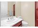 Powder room featuring a sink, toilet, and cabinet storage at 1134 Pandora Canyon St, Henderson, NV 89052