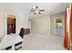 Bright bedroom with carpet, ceiling fan, and doorway leading to the backyard and outdoor areas at 1134 Pandora Canyon St, Henderson, NV 89052
