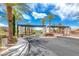 Beautiful community entrance showcasing mature palm trees and lush landscaping at 1134 Pandora Canyon St, Henderson, NV 89052