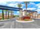 Community entrance featuring a beautiful sign, mature palm trees, and lush landscaping at 1134 Pandora Canyon St, Henderson, NV 89052