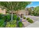 Beautiful home featuring a brick driveway, lush landscaping, and a secure gated entrance at 1134 Pandora Canyon St, Henderson, NV 89052