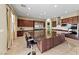 Open kitchen with stainless appliances, dark wood cabinets, and a large island for entertaining at 1134 Pandora Canyon St, Henderson, NV 89052