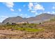 Expansive golf course view framed by picturesque mountains and blue skies dotted with clouds at 1134 Pandora Canyon St, Henderson, NV 89052