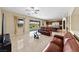 Open-concept living room with access to backyard and adjacent kitchen area with stainless appliances at 1134 Pandora Canyon St, Henderson, NV 89052