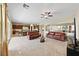 Spacious living room open to the kitchen, featuring tile flooring and comfortable furnishings at 1134 Pandora Canyon St, Henderson, NV 89052
