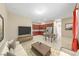 Bright and airy living area adjacent to modern kitchen with stainless steel appliances and dining area at 1134 Pandora Canyon St, Henderson, NV 89052