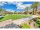 Beautiful community park with lush green lawn, walking paths, and mature palm trees at 1134 Pandora Canyon St, Henderson, NV 89052