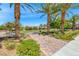 Landscaped park area with mature palm trees, lush greenery, and a paved walkway at 1134 Pandora Canyon St, Henderson, NV 89052