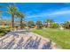 Beautiful park featuring a manicured lawn, trees, benches, and a charming stone path at 1134 Pandora Canyon St, Henderson, NV 89052