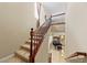 Elegant staircase featuring carpeted steps and a wood railing, leading to the upper level of the home at 1134 Pandora Canyon St, Henderson, NV 89052