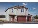 Charming two-story home features a tile roof, three car garage, and stone accents at 1209 Dre Harbor Pl # 82, North Las Vegas, NV 89084