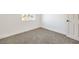 Empty carpeted bedroom featuring a window and paneled door at 1209 S 17Th St, Las Vegas, NV 89104