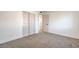 Neutral carpeted bedroom with closet, doorway to another room, and bright, white walls at 1209 S 17Th St, Las Vegas, NV 89104