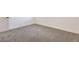 Well-lit bedroom featuring neutral carpet, a white door, and trim at 1209 S 17Th St, Las Vegas, NV 89104