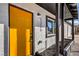 Welcoming facade with a bright yellow front door, modern lighting, and stylish landscaping at 1209 S 17Th St, Las Vegas, NV 89104