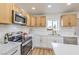 Modern kitchen features stainless steel appliances, white countertops and wood cabinets at 1209 S 17Th St, Las Vegas, NV 89104