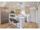 This bright kitchen is equipped with stainless steel appliances, island with bar seating, and modern countertops at 1209 S 17Th St, Las Vegas, NV 89104