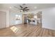 Open-concept living room features modern ceiling fan, wood floors, and adjoins kitchen for seamless entertaining at 1209 S 17Th St, Las Vegas, NV 89104