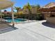 Backyard with a palapa, concrete patio and pool featuring a safety fence at 1921 Moonlight Bluff Ave, North Las Vegas, NV 89084
