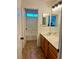 Bathroom features a double vanity, tile flooring, and a door to a bright, clean shower/tub combo at 1921 Moonlight Bluff Ave, North Las Vegas, NV 89084