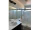 Clean bathroom featuring a glass shower and vanity with modern fixtures at 1921 Moonlight Bluff Ave, North Las Vegas, NV 89084