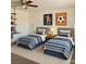 Charming bedroom with two twin beds, decorative artwork, and stylish furnishings at 1921 Moonlight Bluff Ave, North Las Vegas, NV 89084
