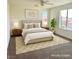 Serene bedroom with a king bed, stylish decor, and ample natural light, perfect for relaxation at 1921 Moonlight Bluff Ave, North Las Vegas, NV 89084