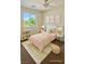 Stylishly staged bedroom featuring a twin bed, bookshelf, and colorful decor at 1921 Moonlight Bluff Ave, North Las Vegas, NV 89084