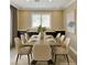 Elegant dining room with modern furnishings and ample natural light at 1921 Moonlight Bluff Ave, North Las Vegas, NV 89084