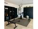 Staged home gym in garage includes exercise equipment, shelves, and storage cabinets at 1921 Moonlight Bluff Ave, North Las Vegas, NV 89084