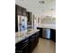 Modern kitchen featuring granite countertops, stainless steel appliances, and dark cabinets at 1921 Moonlight Bluff Ave, North Las Vegas, NV 89084