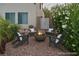 Inviting backyard patio with fire pit, surrounded by comfortable seating and lush greenery at 1921 Moonlight Bluff Ave, North Las Vegas, NV 89084