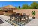 Outdoor dining set beneath a palapa, perfect for outdoor entertaining at 1921 Moonlight Bluff Ave, North Las Vegas, NV 89084