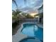 Beautiful in-ground pool with sunset views, framed by privacy fence at 1921 Moonlight Bluff Ave, North Las Vegas, NV 89084