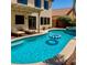 Backyard pool and patio area featuring lounge chairs and outdoor seating at 1921 Moonlight Bluff Ave, North Las Vegas, NV 89084