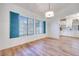 Dining room with blue shutters, wood floors and modern chandelier at 1953 Moyer Dr, Henderson, NV 89074