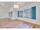 Dining room with blue shutters, wood floors and modern chandelier at 1953 Moyer Dr, Henderson, NV 89074