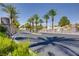 Gated community entrance featuring lush palm trees lining the street, offering a secure and scenic environment at 1953 Moyer Dr, Henderson, NV 89074