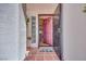 Welcoming entryway with tiled floors, stylish glass block window, and a vibrant pink front door at 1953 Moyer Dr, Henderson, NV 89074