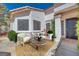 Inviting front patio with stylish seating, a round table, and decorative plants, perfect for relaxing outdoors at 1953 Moyer Dr, Henderson, NV 89074
