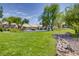 Well-maintained front yard with lush lawn, mature trees, and charming landscaping at 1953 Moyer Dr, Henderson, NV 89074