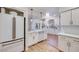 Bright kitchen featuring white cabinets, stainless appliances, and wood floors at 1953 Moyer Dr, Henderson, NV 89074
