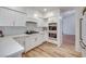 Stylish kitchen featuring white cabinets, stainless appliances and wood floors at 1953 Moyer Dr, Henderson, NV 89074