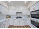 Bright, modern kitchen with white cabinets, subway tile backsplash, and stainless steel appliances at 1953 Moyer Dr, Henderson, NV 89074