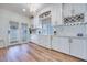 Bright kitchen featuring white cabinets, modern hardware and wood floors at 1953 Moyer Dr, Henderson, NV 89074