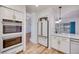 Stylish kitchen featuring stainless appliances, white cabinets, and wood floors at 1953 Moyer Dr, Henderson, NV 89074